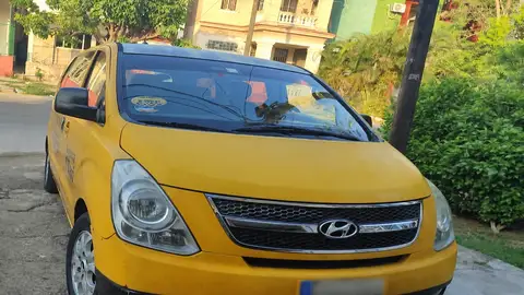 Вид спереди на жёлтый пассажирский автомобиль в Гаване.